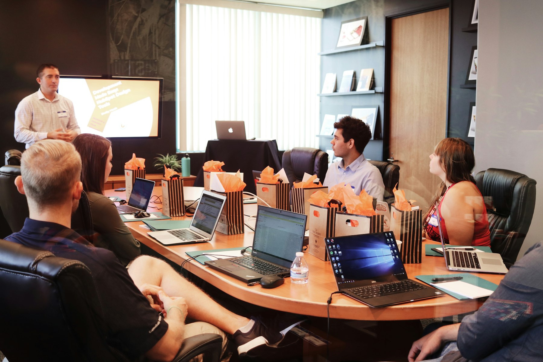 A trainer presenting to a small group around a boardroom table